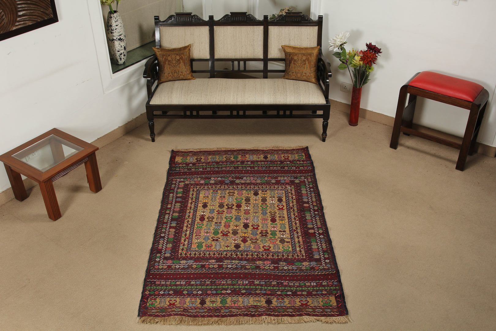 A 4 by 6 feet maliki wool kilim. The colours mainly include green, grey, tan, brick and pink.