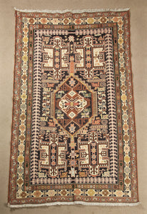 A 4 by 7 feet caucasian wool kilim, the colours used on the carpet are beige,blue,red,orange, black and yellow.