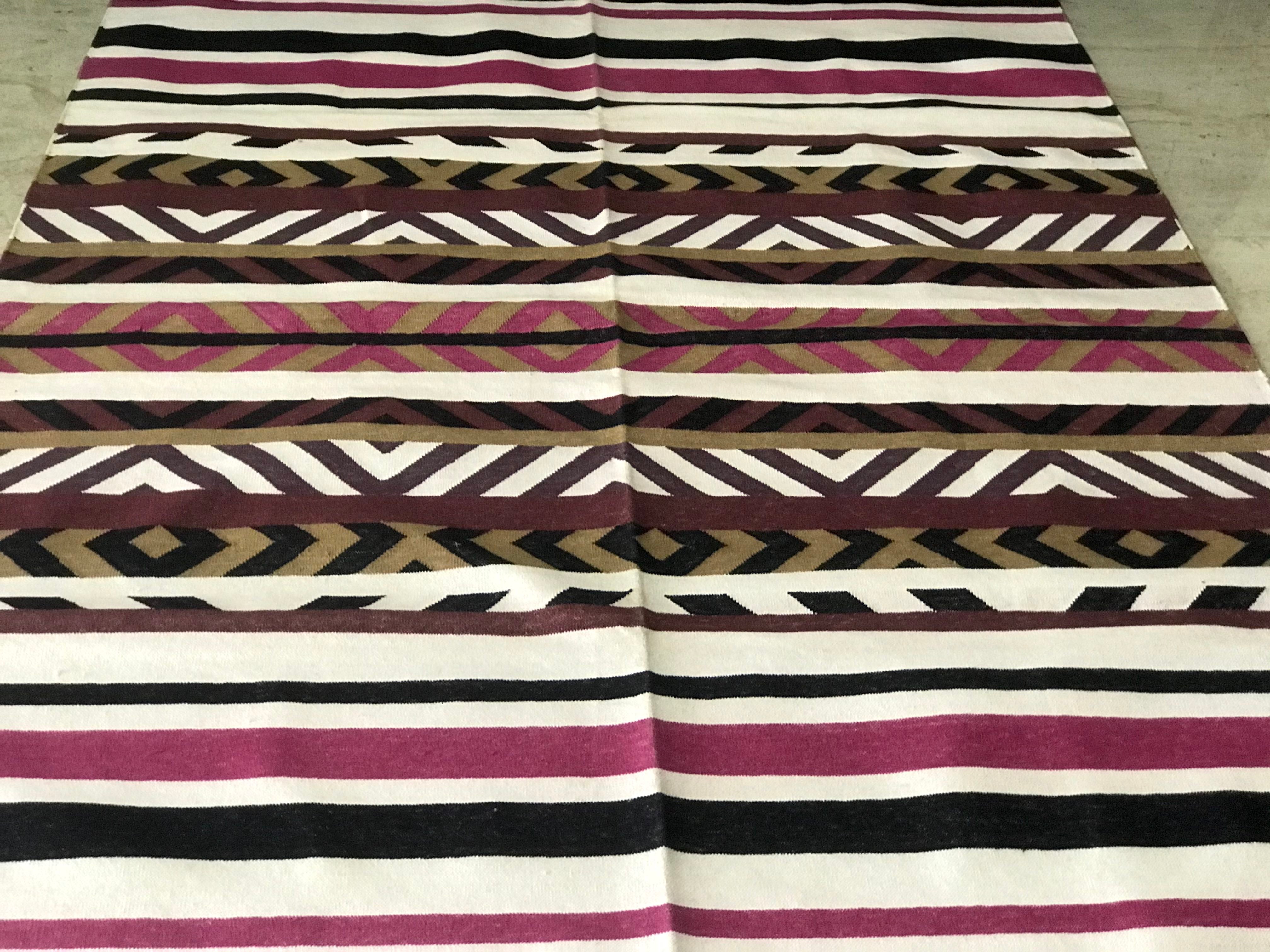 This striped cotton dhurrie is 4 feet by 6 feet.