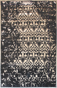 A black and white erased rug that is 8 feet by 10 feet.