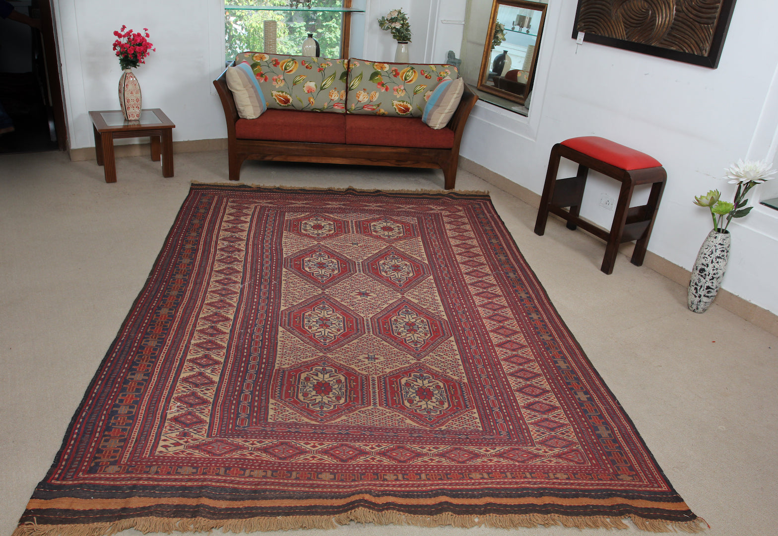 An almost 7 by 10 feet balochi wool kilim. Colours include mainly brick, orange and a light rust.