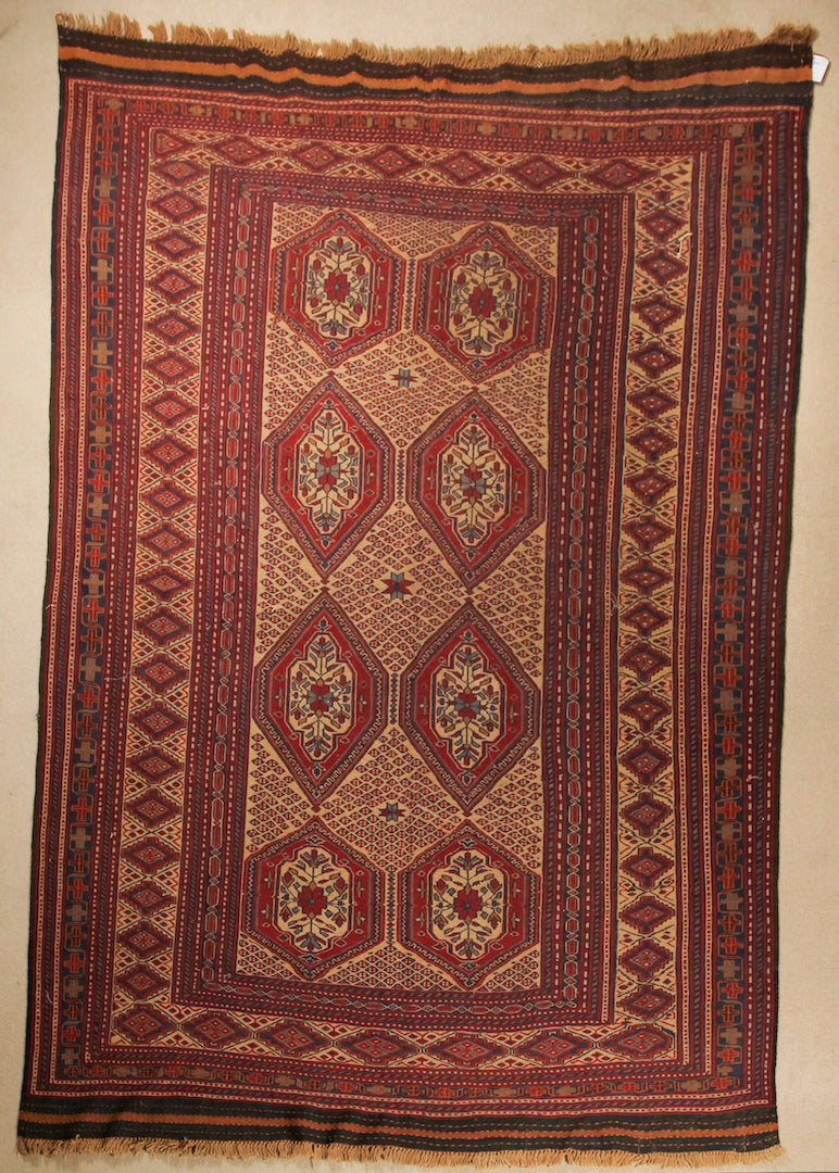 An almost 7 by 10 feet balochi wool kilim. Colours include mainly brick, orange and a light rust.