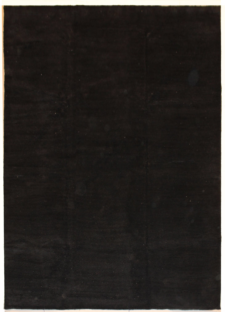 An almost 5.5 by 8 feet rug in plain black.