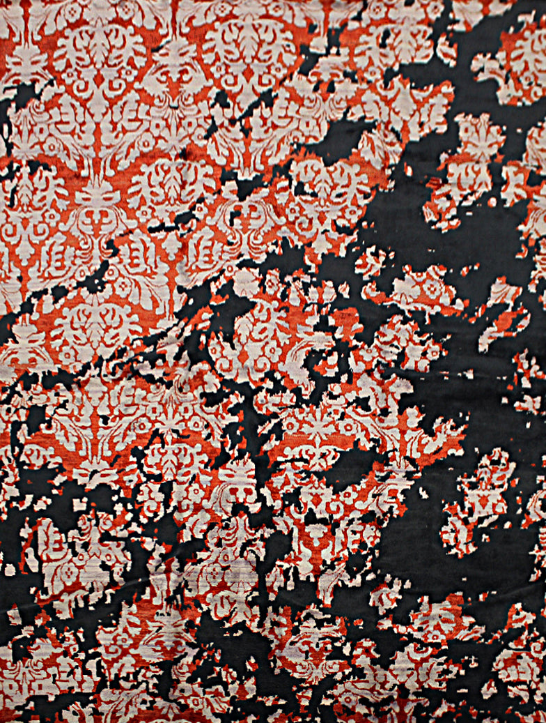 An 8 feet by 11 feet rug with an black, red and white floral erased pattern.