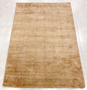 A 4 feet by 6 feet rug in brown.