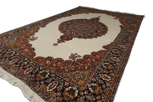 A 6 feet by 9 feet Kashmiri woolen rug, the colours used on the carpet are beige,gree,brown and blue.