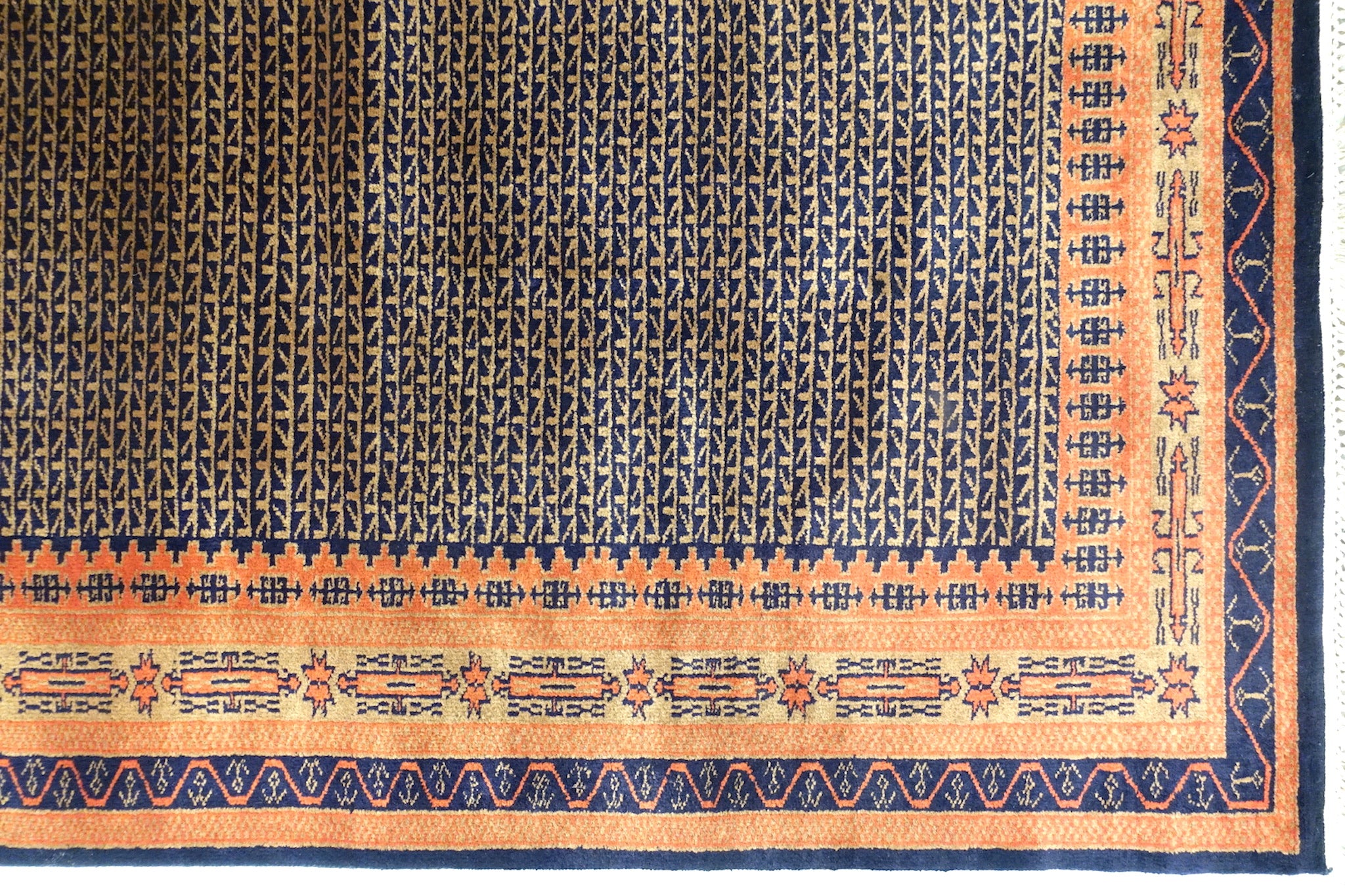 A 4 feet by 6 feet indian wool rug, the colours used on the rug are rust,brown and dark blue.