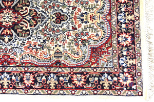 The rug measures 4 feet by 6 feet and is wool rug from central India. The colours used on the rug are beige,camel,blue and red.