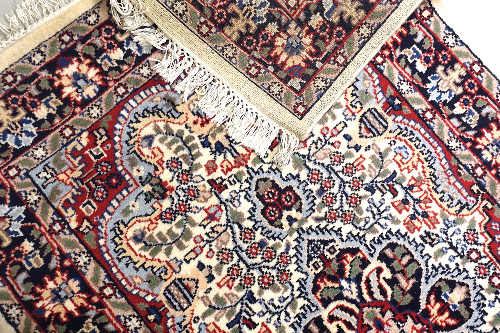 The rug measures 4 feet by 6 feet and is wool rug from central India. The colours used on the rug are beige,camel,blue and red.