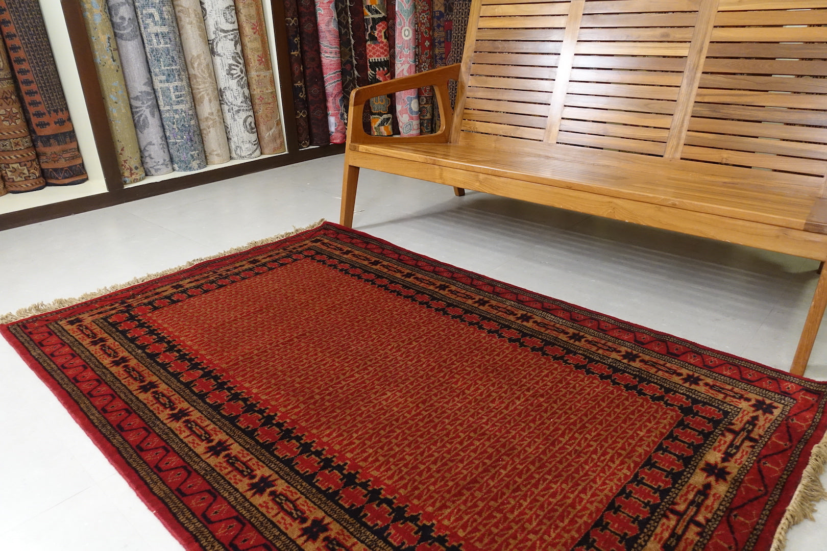 A 4 feet by 6 feet indian wool rug, the colours used on the rug are rust,brown,orange and dark blue.