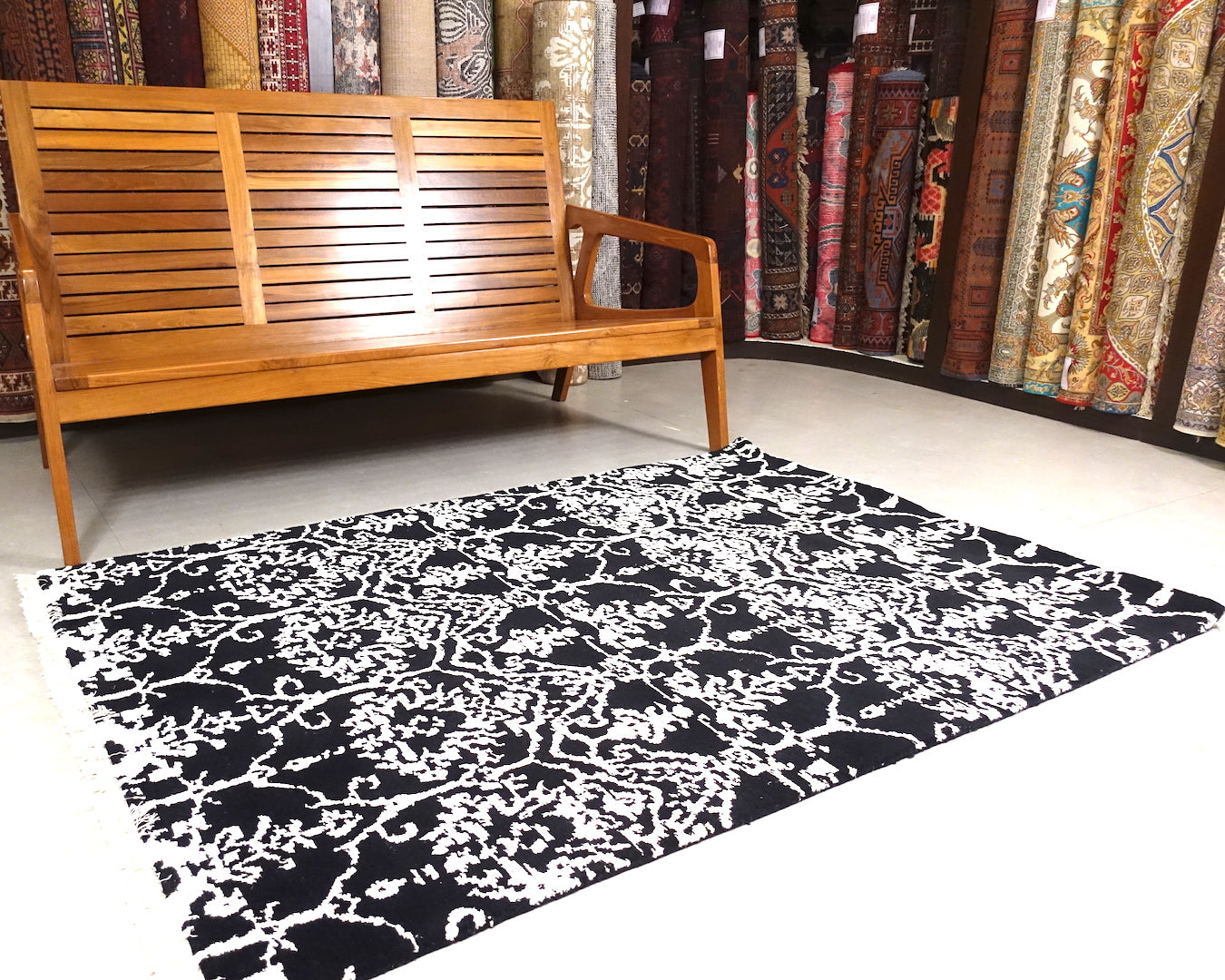 A 4 by 6 feet rug in black and white floral pattern.