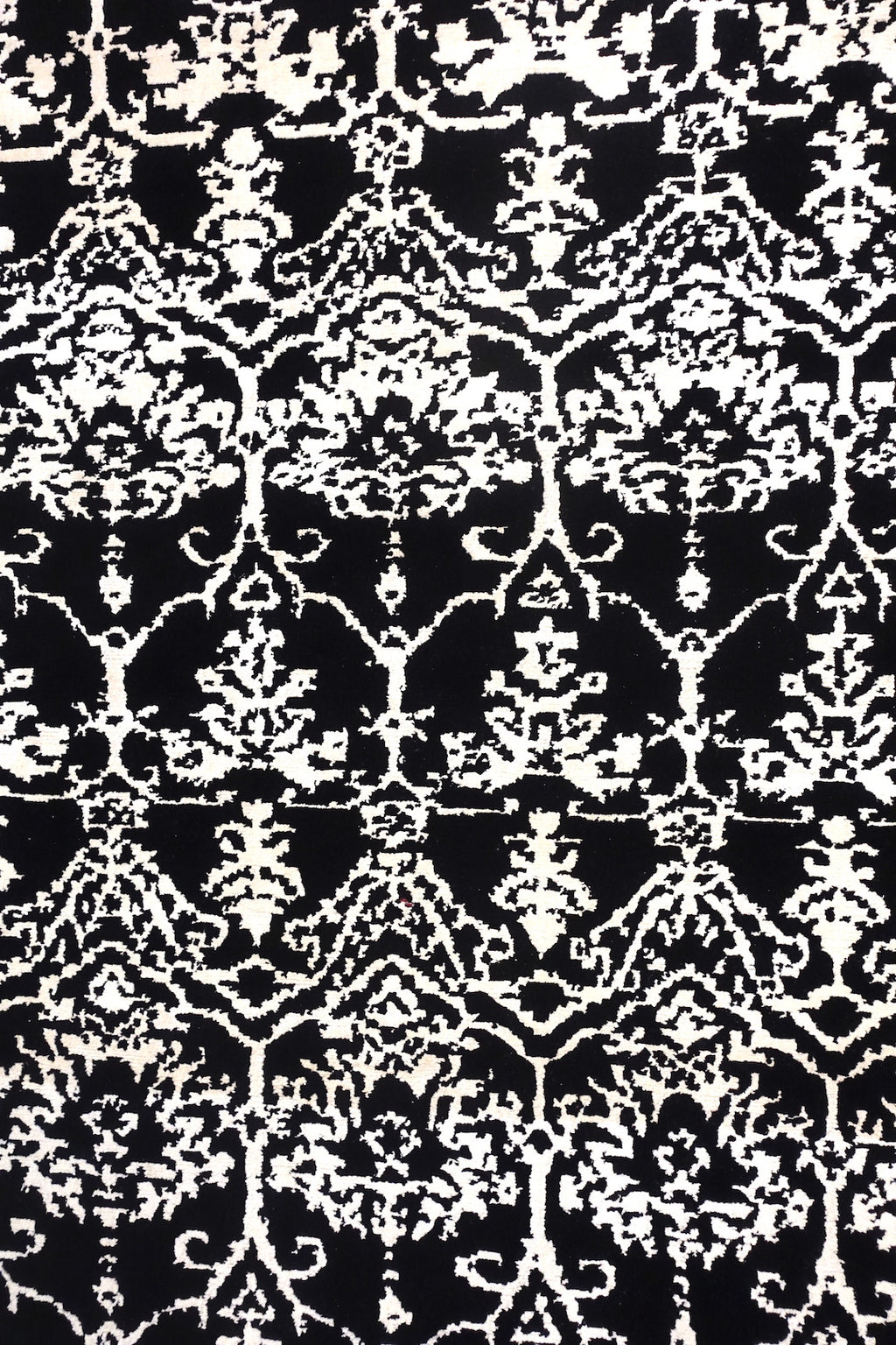 A 4 by 6 feet rug in black and white floral pattern.