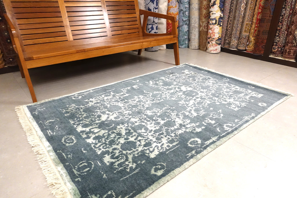 A 6 feet by 4 feet erased rug with floral pattern.