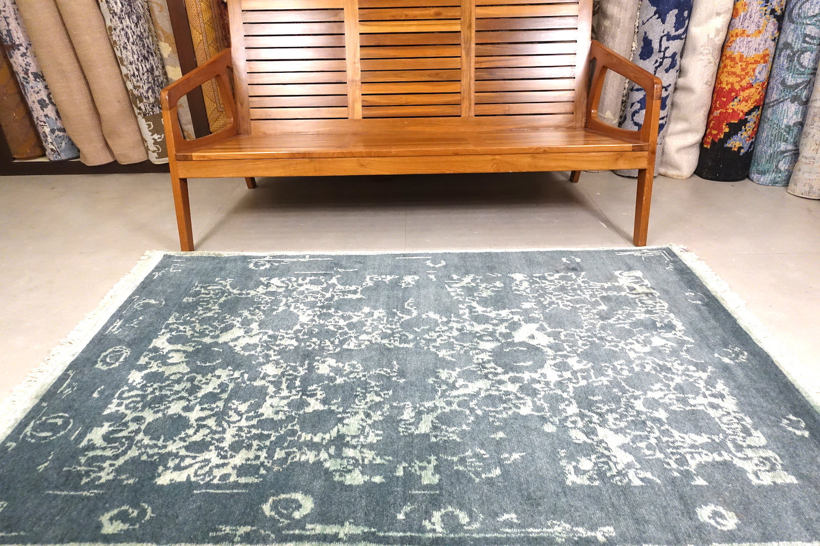 A 6 feet by 4 feet erased rug with floral pattern.