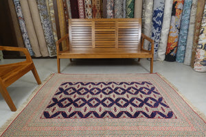 A 5 by 6 feet afghani wool rug. The colours used on the carpet are red, deep blue and beige.