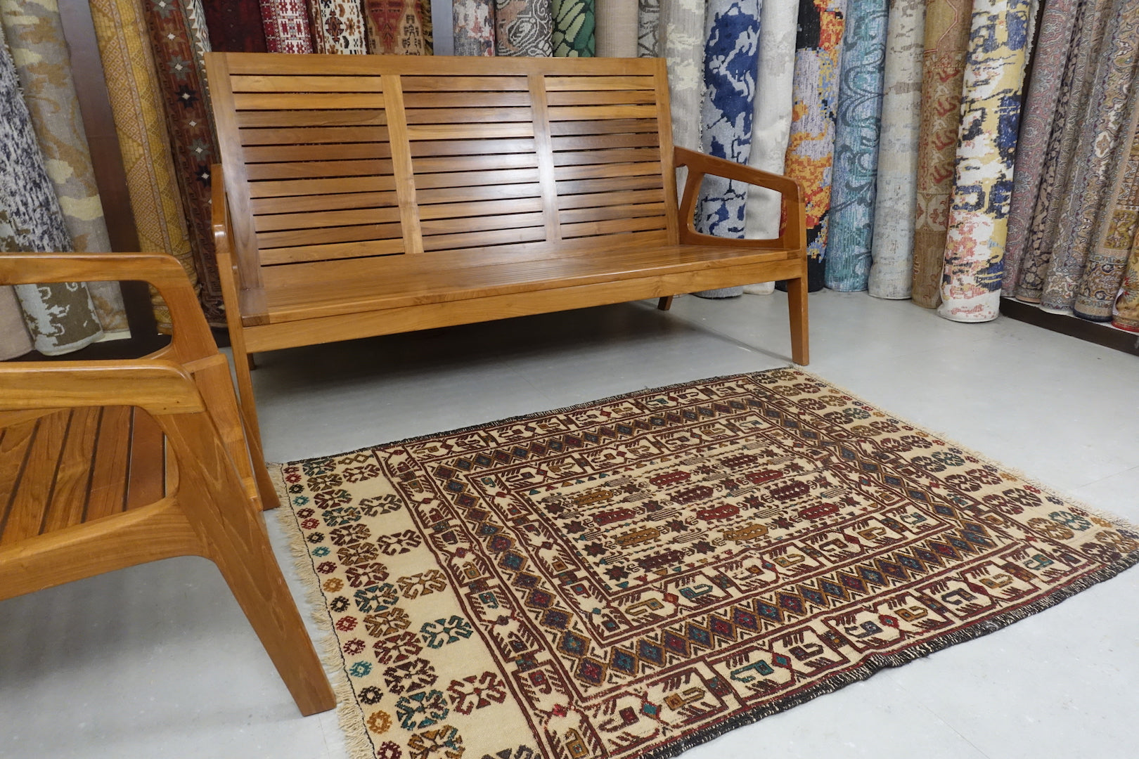 A 3.8 feet by 5 feet wool kilim, the colours used on the rug are blue, beige, brown and tan.