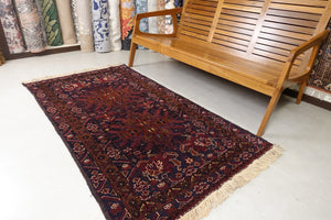 It is a 3.5 feet by 6 feet Afghan wool rug. The colours used are dark blue, brick red and rust.