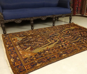 A 4 by 6 feet balochi rug. The colours primarily include beige, brick, rust, blue and green.