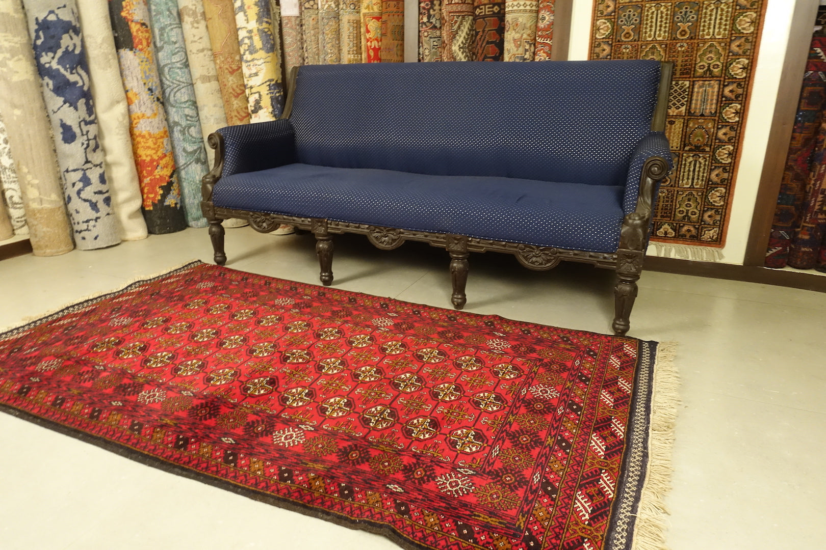 A 4 feet by 6.5 feet Afghan wool rug, the colours used on the rug are red,blue,beige and rust.