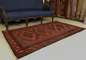 A 4 by 7 feet balochi wool rug.