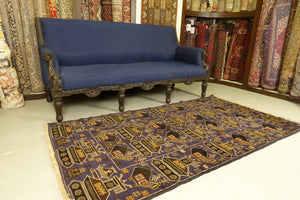 A balochi wool rug that measures 3.5 feet by 6 feet. The colours used on the rug are blue, orange, beige and rust.