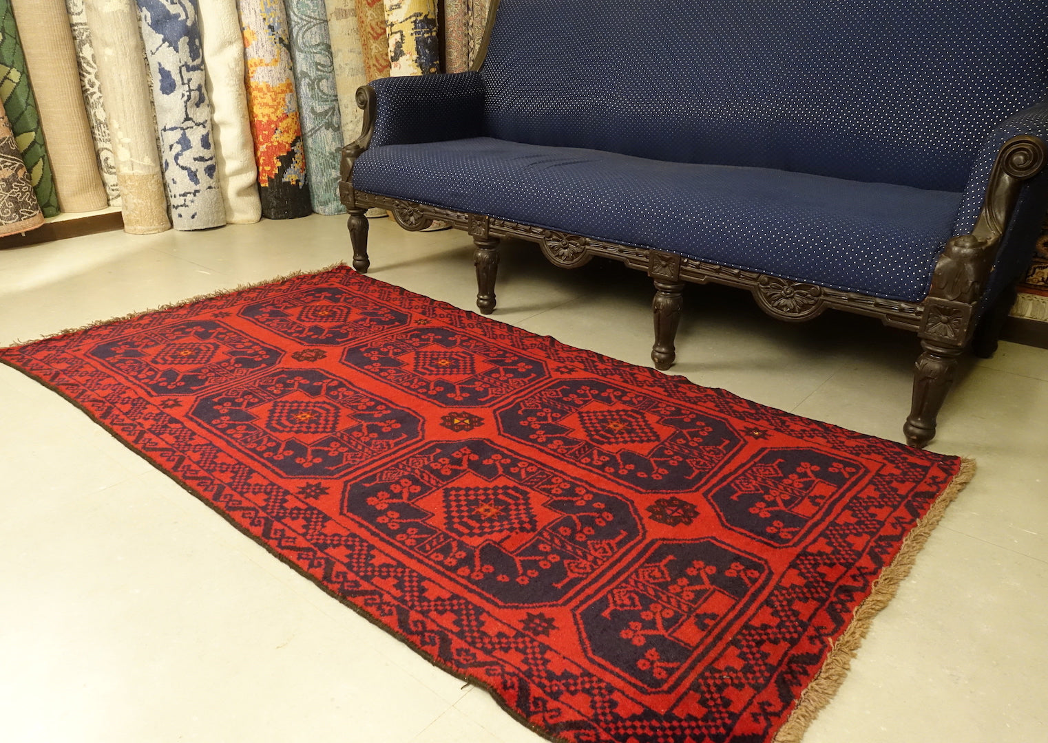 A 3.5 feet by 6.5 feet turkoman wool rug. The colours used are deep red and dark blue.