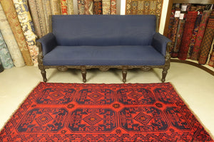 A 3.5 feet by 6.5 feet turkoman wool rug. The colours used are deep red and dark blue.