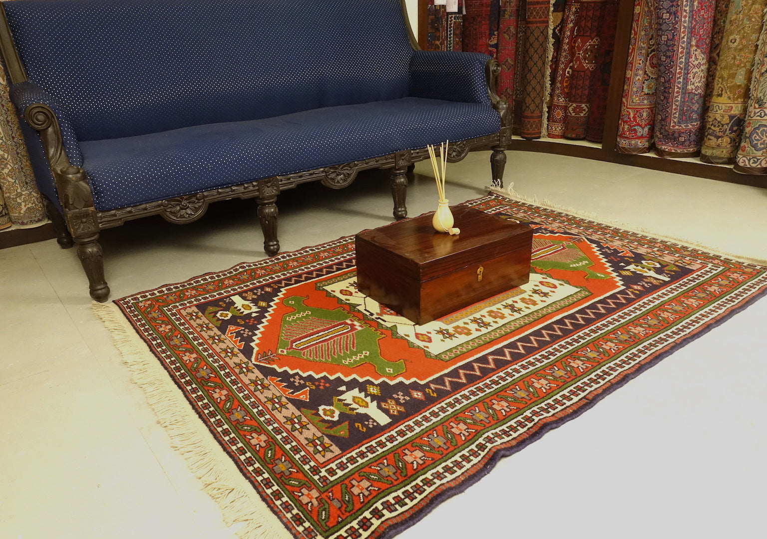 A 4 feet by 6 feet balochi wool rug, the colours used on the rug are red, green and beige.