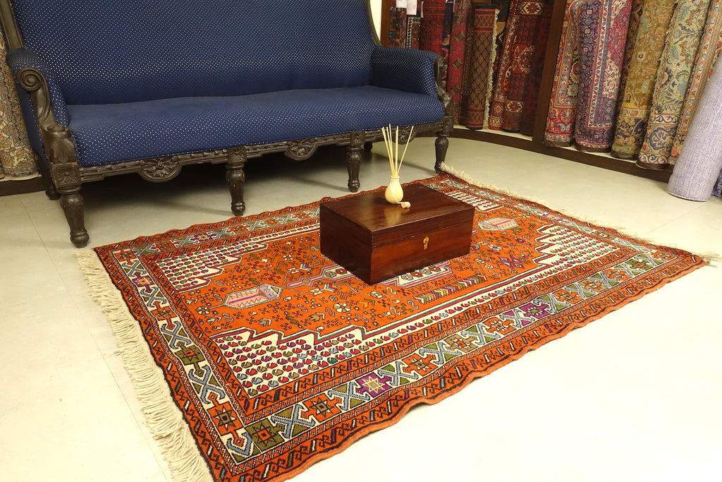 A 4 by 6 feet balochi wool rug, the colours used on the carpet are blue, brick, green and beige.