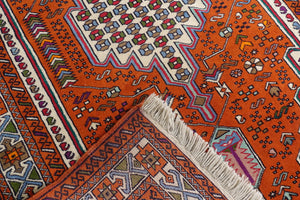 A 4 by 6 feet balochi wool rug, the colours used on the carpet are blue, brick, green and beige.