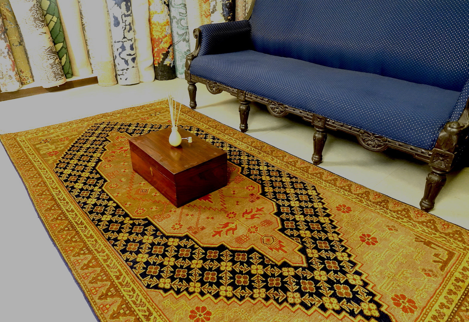It is a 4 feet by 8 feet antique wool rug from samarkand. The colours used on the rug are orange,gold and blue.