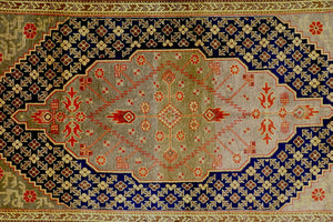 It is a 4 feet by 8 feet antique wool rug from samarkand. The colours used on the rug are orange,gold and blue.