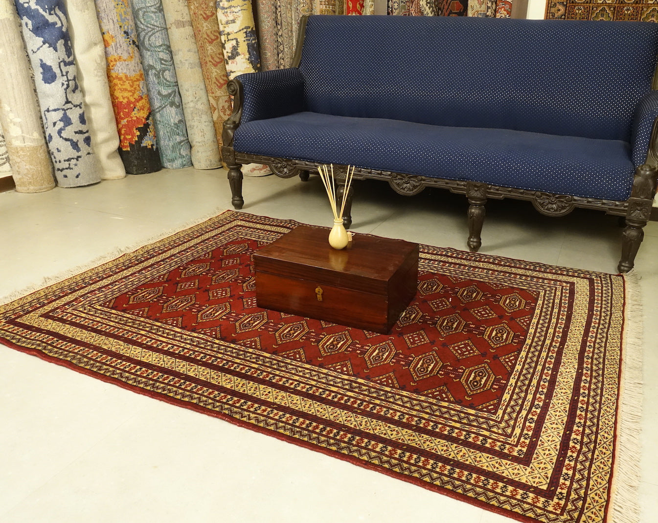 A 4 by 6 feet afghani wool rug. The colours used on the carpet are red, tan, deep blue and beige.