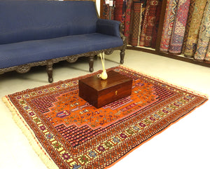 A 4 by 6 feet balochi wool rug. Shades used are primarily brick, purple, green, beige, black and cherry.