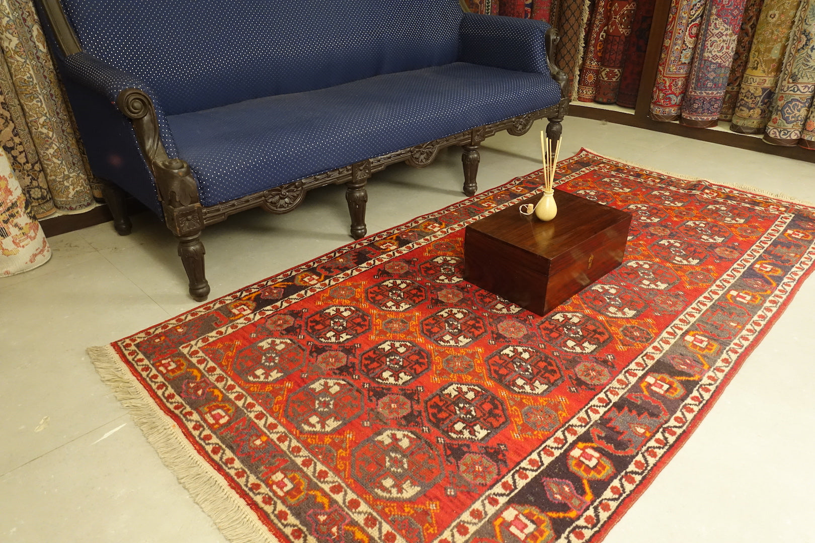 A 3.75 feet by 7.5 feet antique turkoman rug, the colours used on the rug are deep red,blue,yellow,pink and rust.