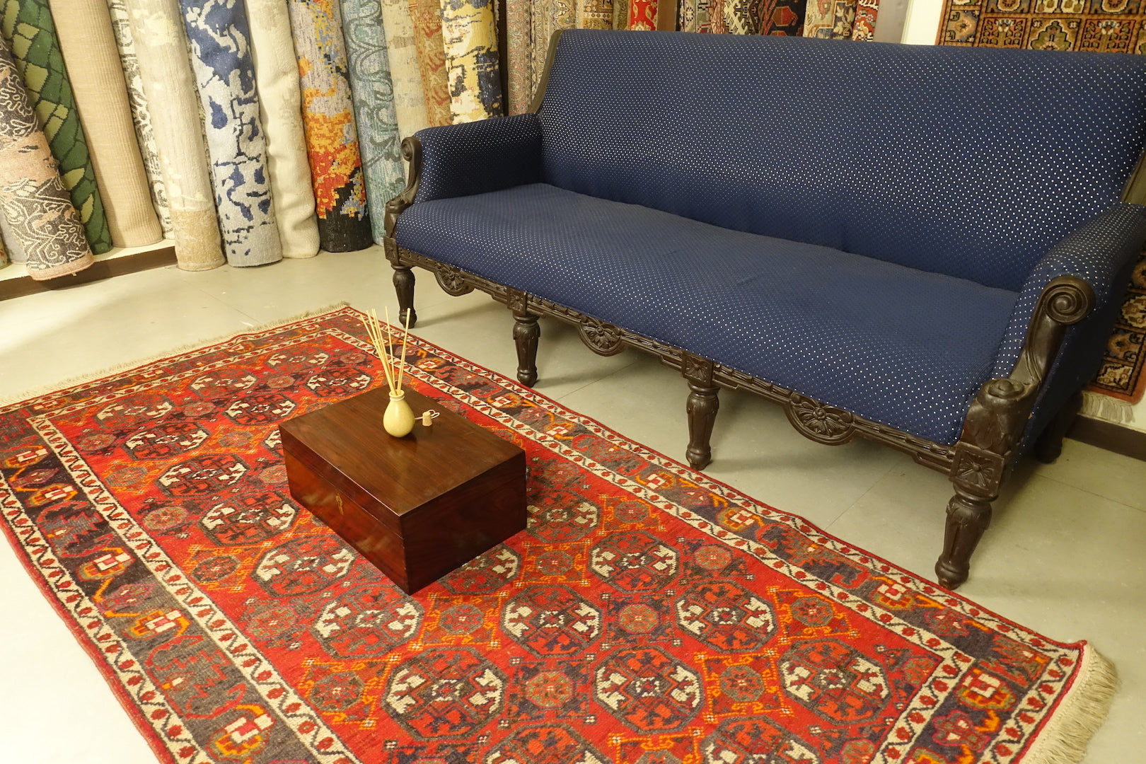 A 3.75 feet by 7.5 feet antique turkoman rug, the colours used on the rug are deep red,blue,yellow,pink and rust.
